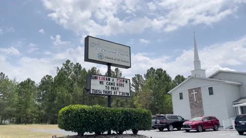 FBI raided Church Assembly of Prayer on Old Tobacco Road sign pan Stock Footage 198570859