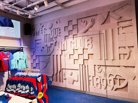 FC Barcelona store interior with jerseys and mural reading Ms que un club i.. Stock Photos
