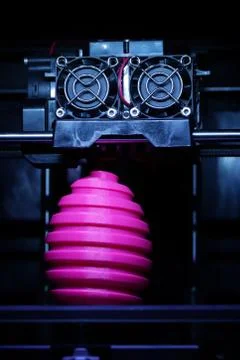 FDM 3D-printer manufacturing wound pink easter egg sculpture - front view on  Stock Photos