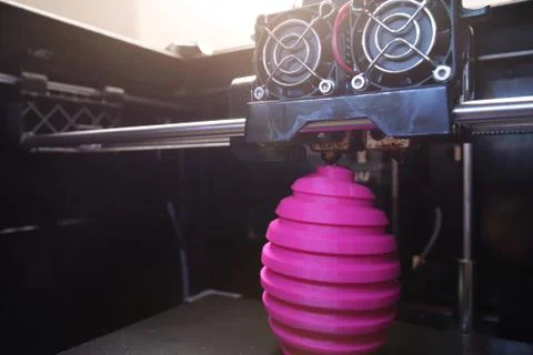 FDM 3D-printer manufacturing wound pink easter egg sculpture - wide angle vie Stock Photos
