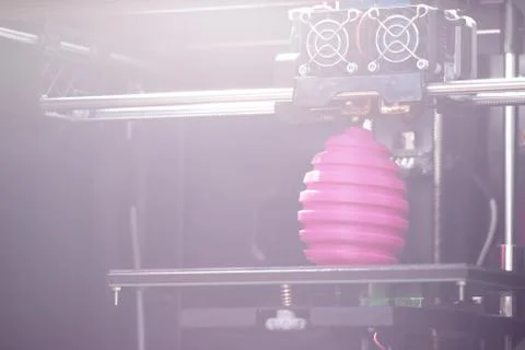 FDM 3D-printer manufacturing wound pink easter egg sculpture - diagonal view  Stock Photos