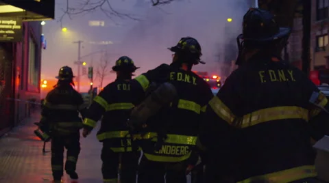 FDNY firefighters walking toward fire smoke silhouetted slow motion 4k NYC Stock Footage 48700308