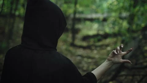 Fear and horror, ancient curses. The witch conjures in the forest, evokes the Stock Footage 221414071