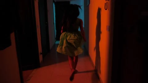 Fear, danger - indian girl runs down the hall feeling she is in danger Stock Footage