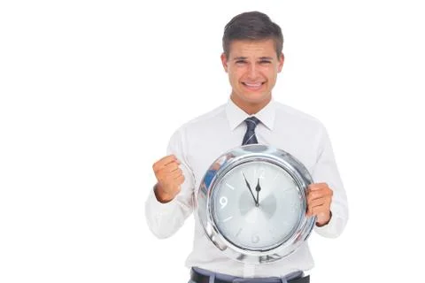 Fearful businessman holding and looking at clock Stock Photos
