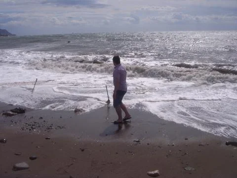 Fearless man at ocean waves Stock Photos