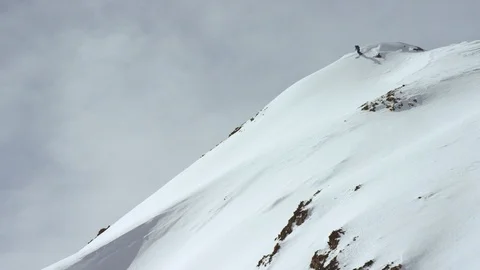 Fearless skier speeding through slopes of snowy mountains during winter Video stock 116787761