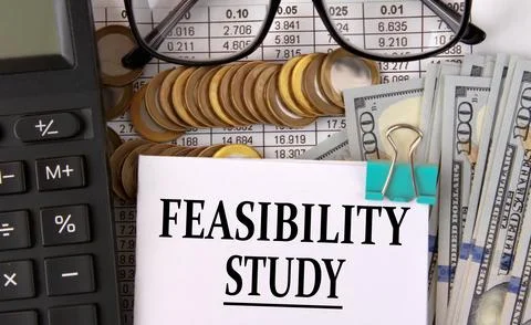 FEASIBILITY STUDY - words on a white piece of paper on the background of a .. Stock Photos