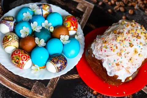 The Feast of Holy Easter. Painted eggs and Easter cakes on platters, decora.. Stock Photos