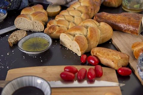 Feast, messy table. Bread in the shape of a braid. Sweet Challah. breakfast Stock Photos