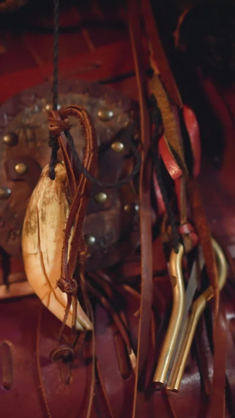 Feather from bone laces and vargan hand on shaman costume Stock Footage 309879242
