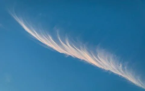 Feather-like Cirrus Cloud formation crossing sky Stock Photos