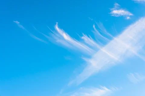 Feather clouds on deep blue sky background Stock Photos