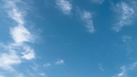 Feather clouds move across the blue sky during the day Stock Footage 156238599