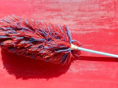 Feather duster on a red background, cleaning tool. 写真素材