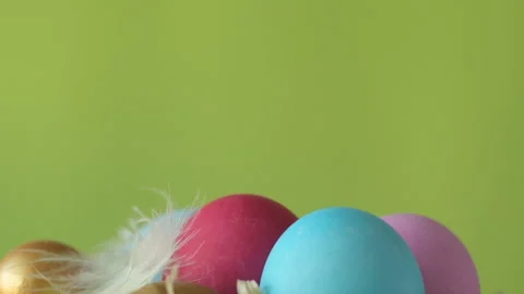 Feather falling on colorful easter eggs Stock Footage 148287747