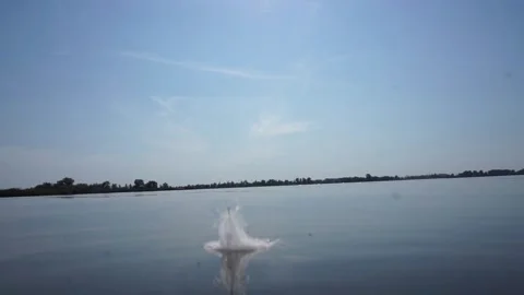 Feather floating on the water moving on the waves. Stock Footage 143019701