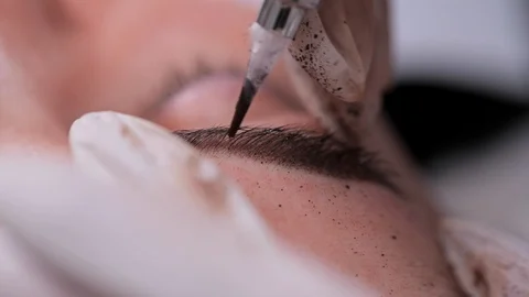 Feather paint on the eyebrows. Pigment application. Close-up, Permanent Makeup Stock Footage 106895481