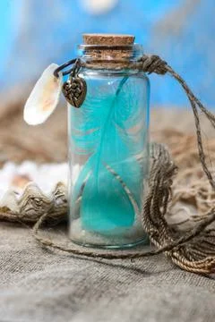 Feather prisoned in bottle Stock Photos