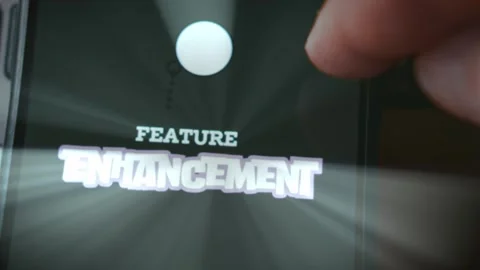 Feature Enhancement themed graphic presentation viewed on smartphone Stock Footage 289093023