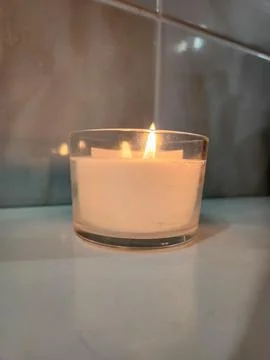 Featured object scented candle with a soft glow in a glass holder Stock Photos