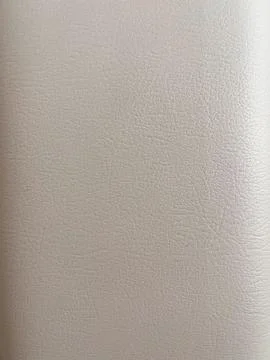 Features a close-up texture of light beige or off-white faux leather. Stock Photos