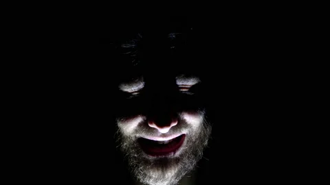 Features of a male, bearded face, backlit in the dark. Close-up of a man's face Stock Footage 159649144