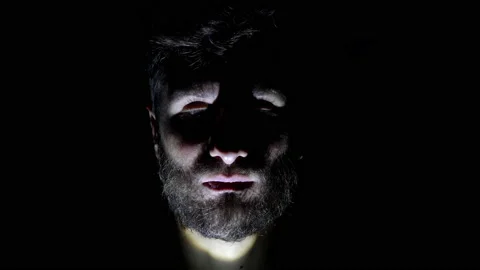 Features of a male, bearded face, backlit in the dark. Close up of a man's face Stock Footage 159649249