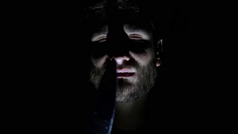 Features of a male, bearded face, backlit in the dark. Close-up of a man's face Stock Footage 159649364