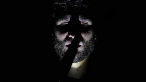 Features of a male, bearded face, backlit in the dark. Close-up of a man's face Stock Footage 159649451