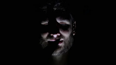 Features of a male, bearded face, backlit in the dark. Close-up of a man's face Stock Footage 159650480