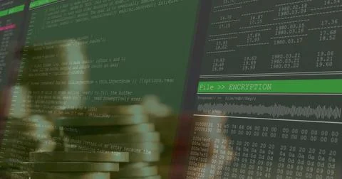 Featuring blurred coin stacks in coding workspace with two monitors showing code Stock-Fotos