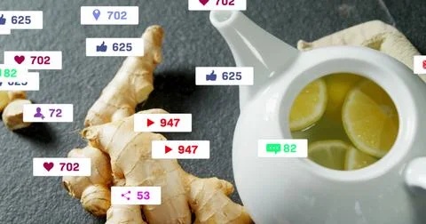 Featuring ceramic teapot holding lemon slices on countertop, with ginger, media Stock Photos
