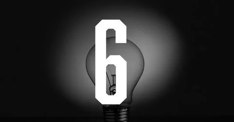 Featuring clear incandescent bulb on flat dark surface showing filament, metal Stock Photos