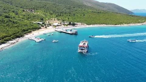 Featuring crystal-clear turquoise waters, a pebble beach, a pirate-style ship Stock Footage 329387094