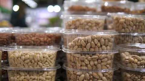 Featuring a multitude of transparent plastic with whole peanuts. Stock Footage 325888038