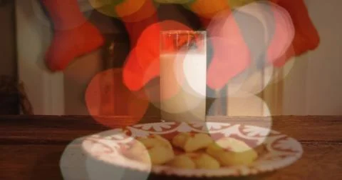 Featuring patterned plate with cookies and tall glass of milk on wood table, red Stock Photos