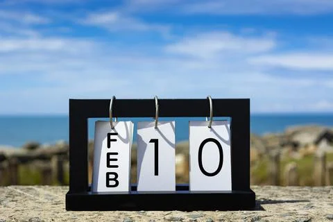 Feb 10 calendar date text on wooden frame with blurred background of ocean Stock Photos