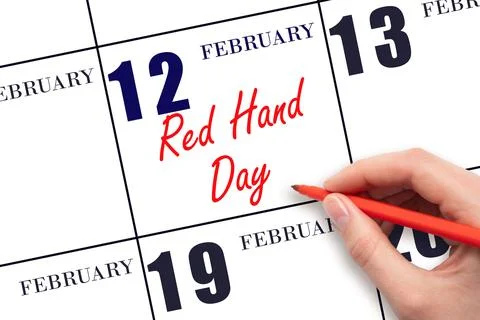 February 12. Hand writing text Red Hand Day on calendar date. Save the date. Stock Photos