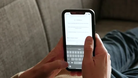 FEBRUARY 20, 2023: ChatGPT iPhone Screen Close-up of an Example of Chat a Person Stock Footage 233609891