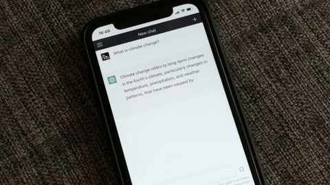 FEBRUARY 20, 2023: ChatGPT iPhone Screen Close-up of an Example of Chat a Person Stock Footage 233610067