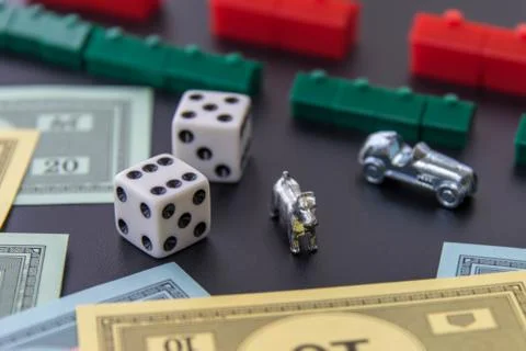 February 8, 2015: Houston, TX, USA.  Monopoly money, playing pieces and dice Stock Photos