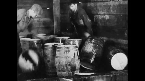 Federal agents destroy barrels of alcohol during Prohibition. Stock Footage