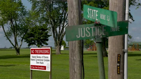 Federal Bureau of Prisons rack focus to Justice and State Street Signs Stock Footage 147954127
