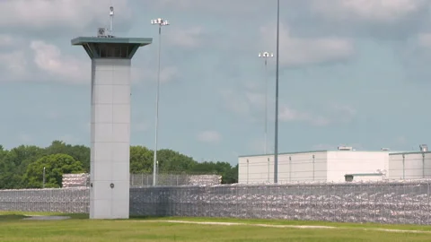Federal Prison Tower with Barbed Wire Fence Stock Footage 147953888