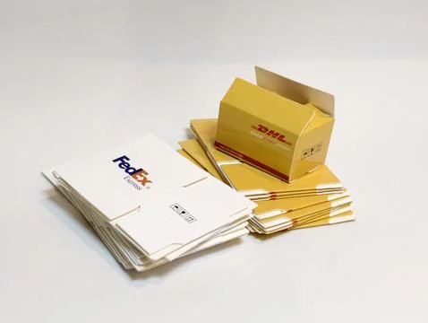 FedEx And DHL Express Packaging: Stacked Envelopes And Boxes Ready For Shipment Stock Photos
