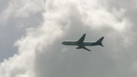 FedEx Boeing 767-300F N117FE Climbing in Cloudy Sky Stock Footage 345091820