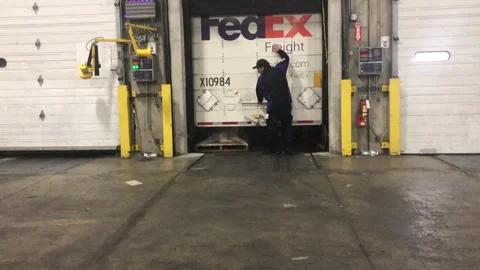 Fedex driver opens up trailer door at supply chain facility Stock Footage 264116742
