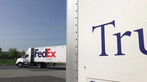 Fedex Freight Tractor Trailer Pulls Out of Loading Dock Stock Footage 241684786