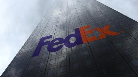 FedEx logo on a skyscraper facade reflecting clouds. Editorial 3D rendering Stock Illustration
